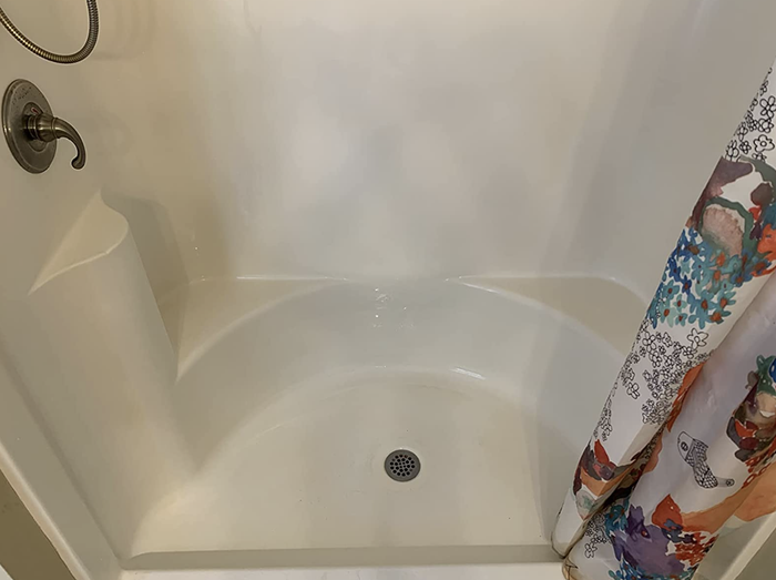 The same reviewer's shower now spotless and looking brand new after using the stain remover
