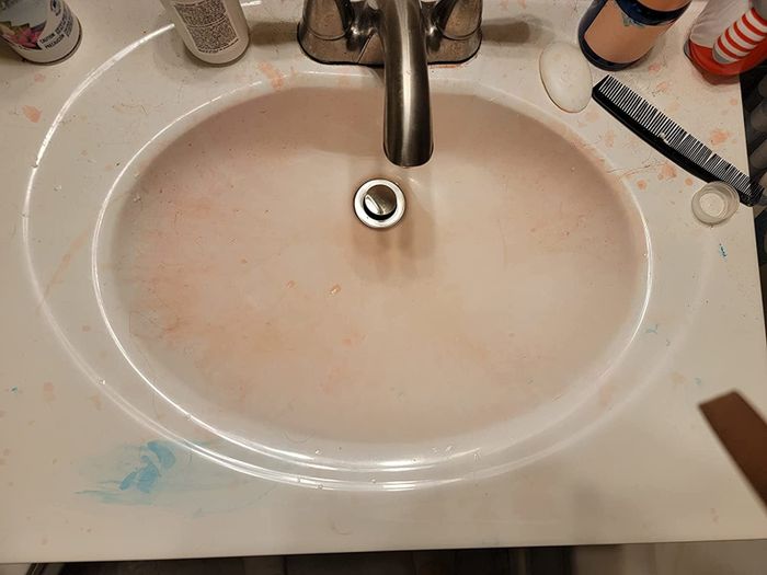 A reviewer's 'before' photo of their sink stained with hair dye.
