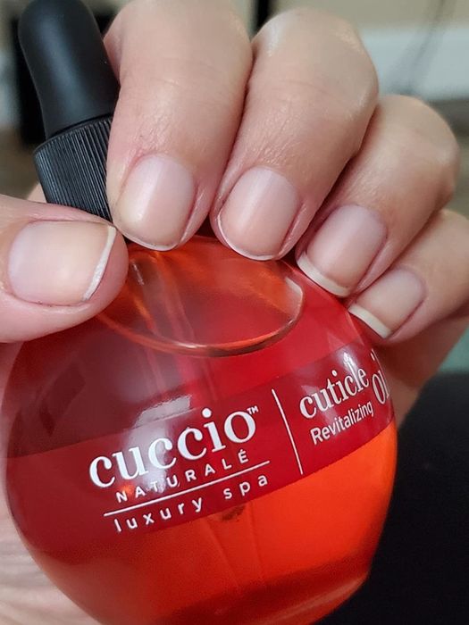 A different reviewer showcasing the pomegranate-infused cuticle oil.