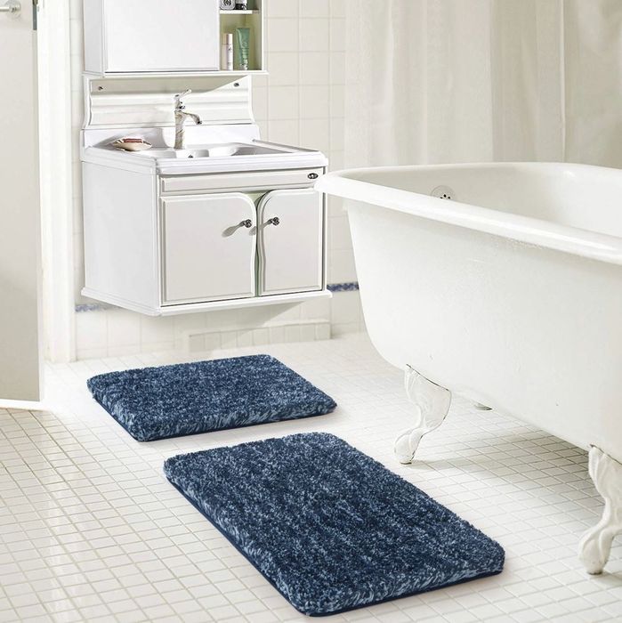 A pair of soft blue bath mats