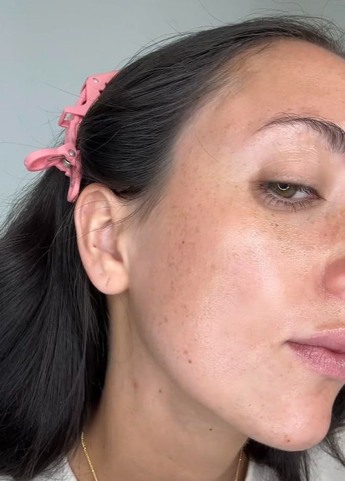 A close-up shot of a person’s face highlighting smooth, naturally flawless skin texture.