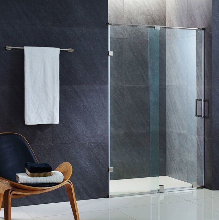 A glass shower door paired with a bathroom chair and matte-finished walls
