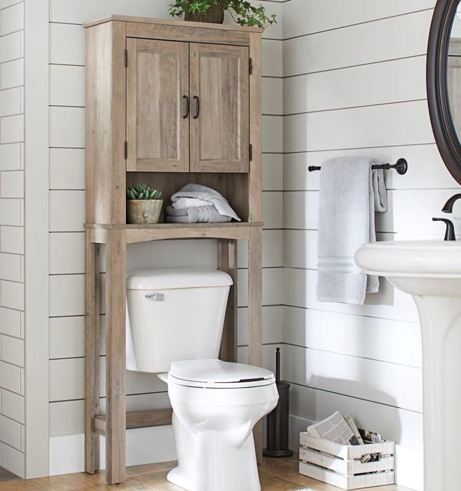A complete bathroom featuring a wooden over-the-toilet shelf and cabinet