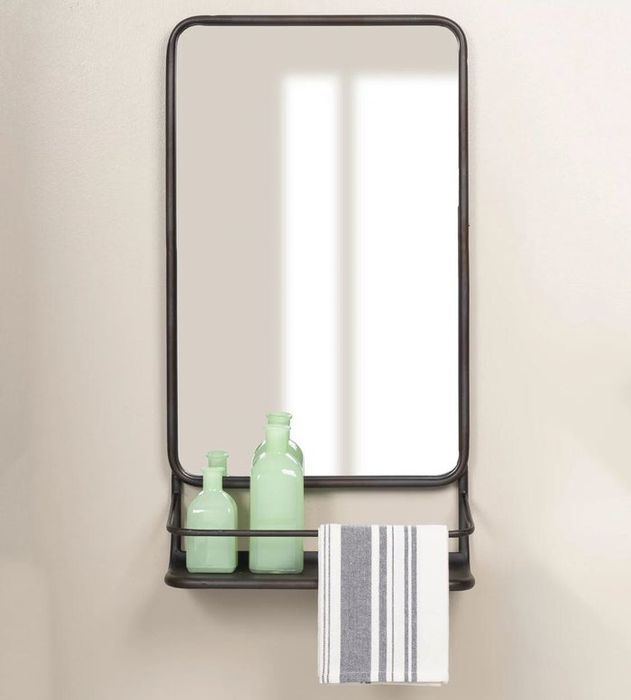A sleek black square wall mirror featuring a shelf, adorned with green bottles and a striped hand towel
