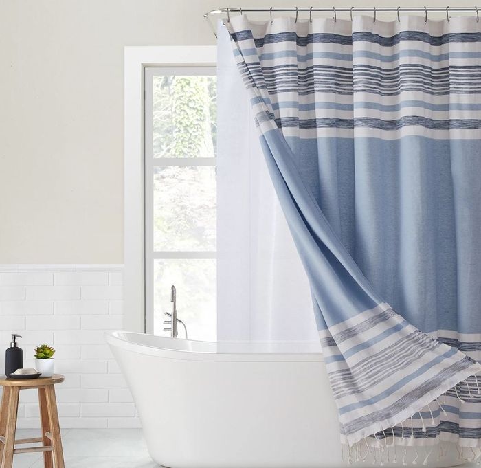 A two-piece blue striped shower curtain with a matching liner