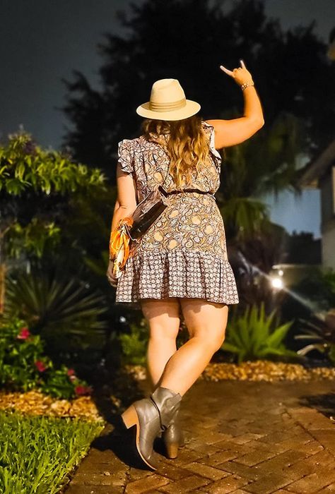 A reviewer photo showing someone styling a dress with rich, dark brown cowboy boots.