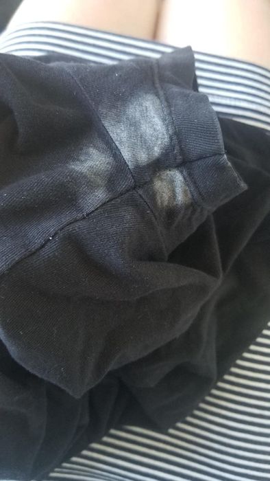 Reviewer's before shot of a black shirt showing white deodorant stains.