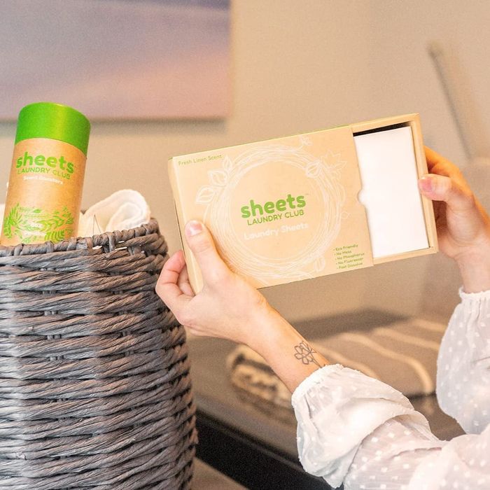 A person unboxing a set of sheets.