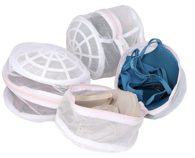 Four mesh laundry bags on display, each opened to show bras inside. These bags offer organized storage and protect delicate lingerie during washing.