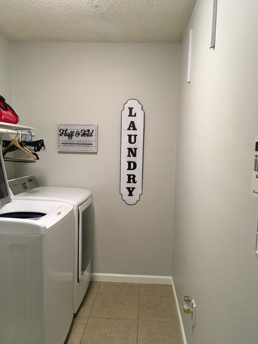 The two racks collapsed flat against the wall, with no clothes on them.
