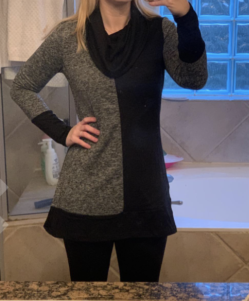 photo of the reviewer wearing the sweater in black and gray