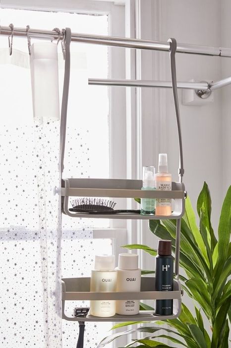 caddy hanging on the shower curtain bar with the two arms parallel to each other