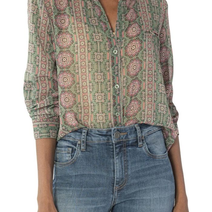 A top with a green and pink geometric pattern