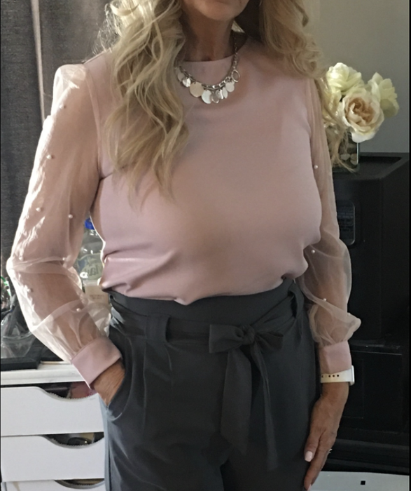 a photo from a reviewer featuring the shirt in pink