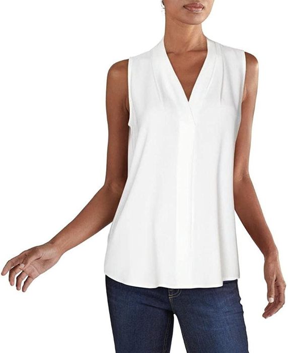 The model is wearing the white sleeveless top