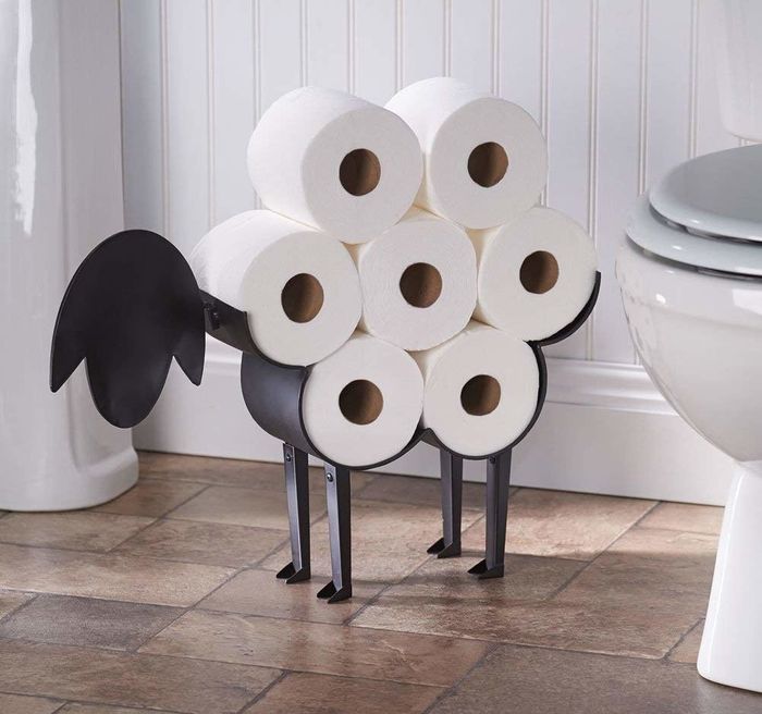 A metal sheep holder with seven rolls of toilet paper that resemble its wool.
