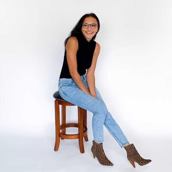 A reviewer is seen wearing the stylish black high turtleneck tank, exuding sophistication and comfort.