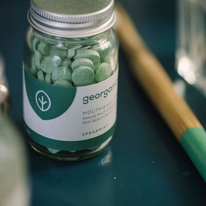 glass jar filled with green tablets