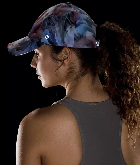 Model sporting the blue and violet patterned hat.
