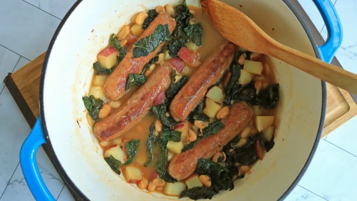 A comforting Dutch oven filled with a hearty sausage and bean stew.