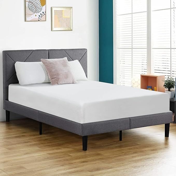 A contemporary upholstered bed paired with a white mattress in a chic bedroom arrangement