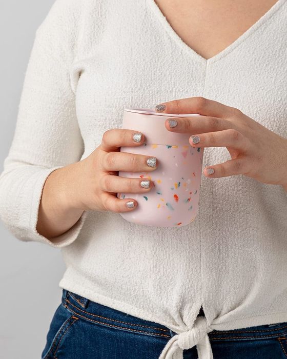 A model holding the pink-patterned mug