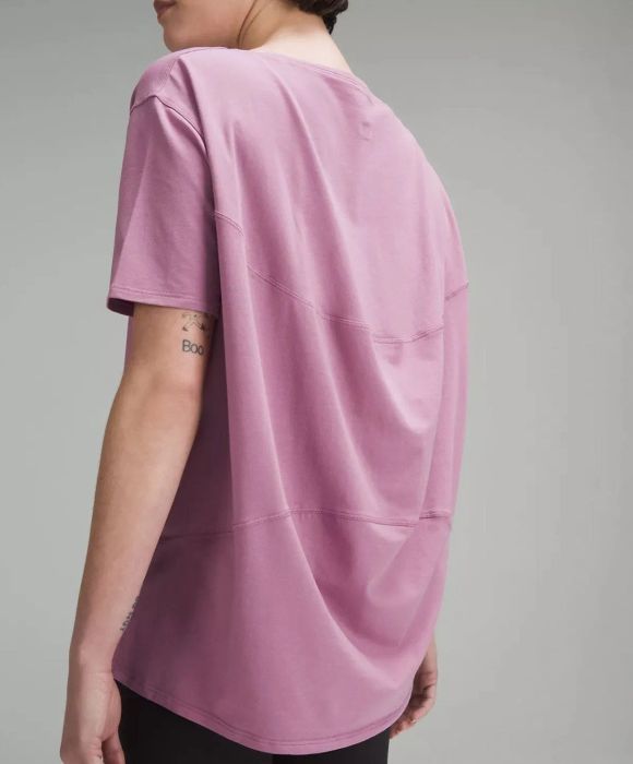 Side close-up of a different model wearing the pink tee.