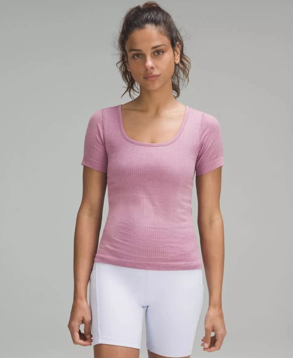 Model sporting a pink crewneck short-sleeve paired with white biker shorts