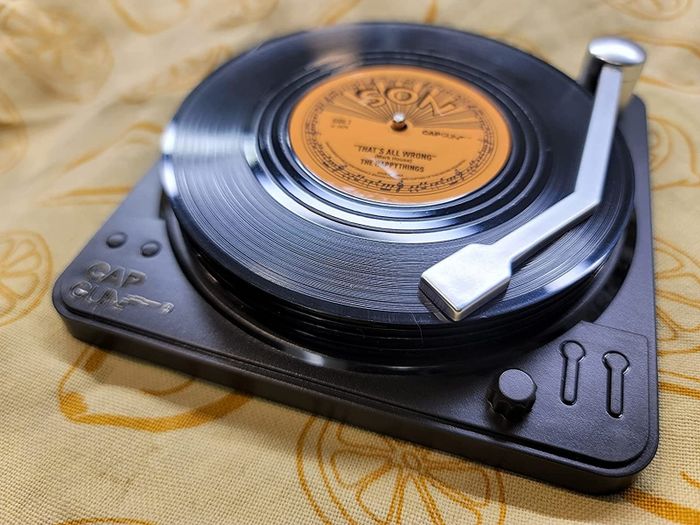 A charming set of coasters placed on a stylish record player stand