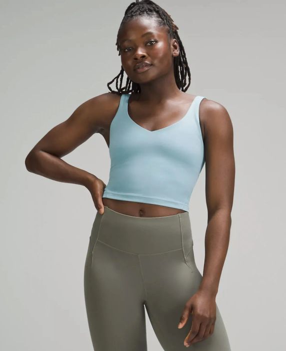 Model dressed in the blue v-neck tank and leggings