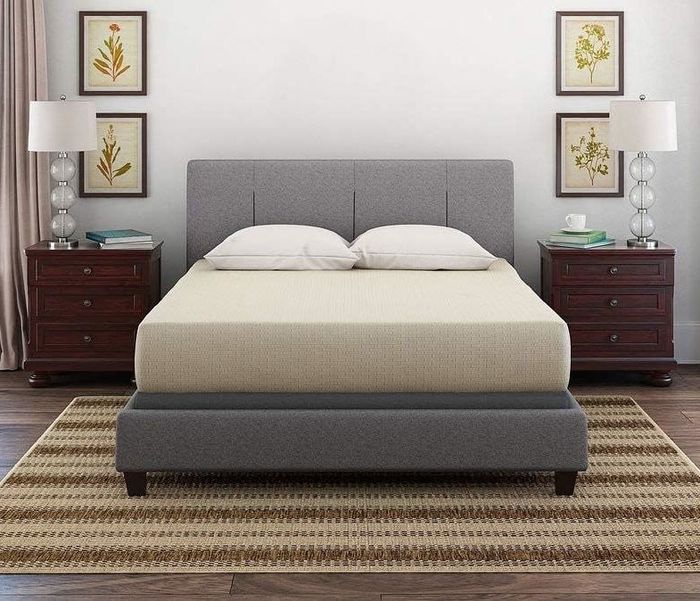 A modern-themed bedroom featuring a bed, two nightstands, and stylish lamps, creating a sleek, inviting atmosphere.