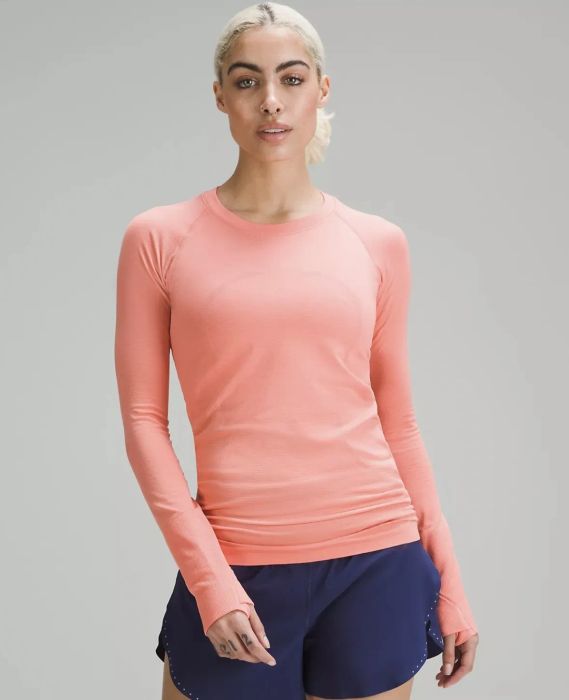 Model wearing the pink long-sleeve shirt.