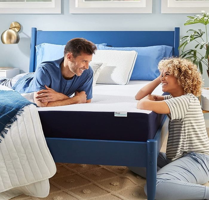 Two models lying on a cooling gel memory foam mattress, demonstrating its comfort and support.
