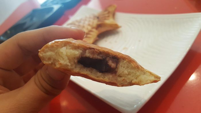 A reviewer revealing the delicious filling inside the pancake.
