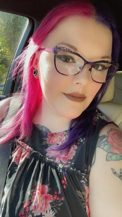 Reviewer with half black hair and half black-pink hair.