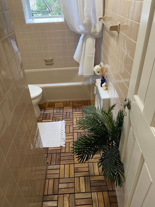 the same bathroom now with teak tiles covering the floor