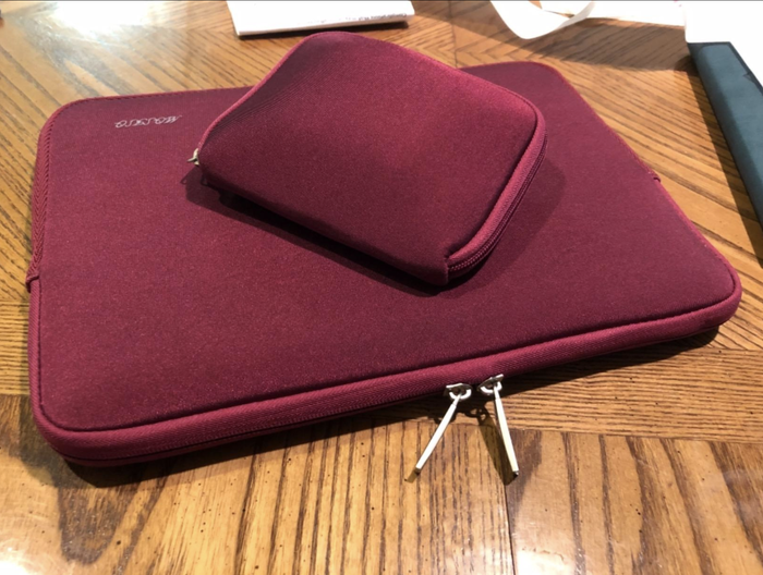 A red zippered case along with a smaller case.