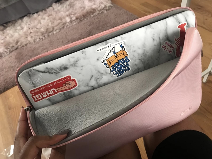 A review image showing a laptop inside a pink padded sleeve.