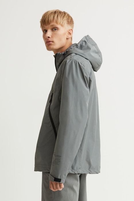 Model wearing the grey windbreaker