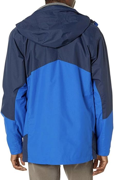 Another model is seen wearing the Columbia jacket in blue.