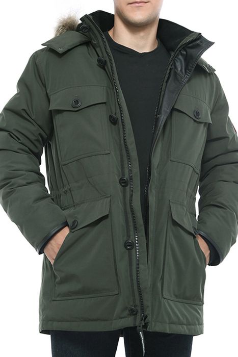 A model is wearing the parka in green.