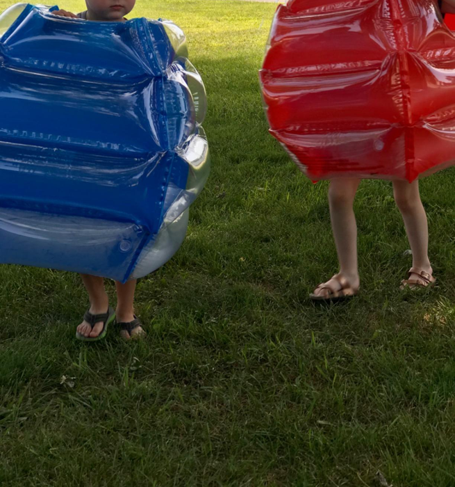 A reviewer’s photo of their kids wearing body bumpers and playing outdoors