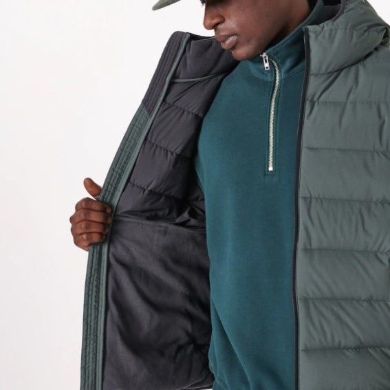 The same model wearing the jacket in grey