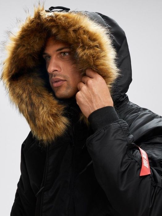 Model wearing the parka with the synthetic fur-lined hood pulled up