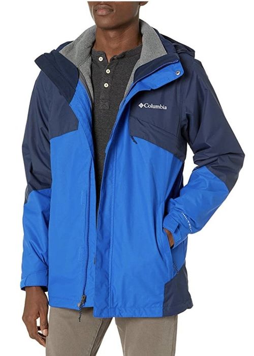 A model is wearing the Columbia jacket in blue.