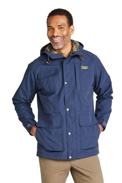 A model is seen wearing a blue jacket.