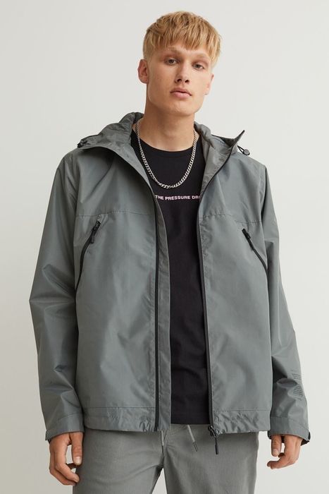 Model wearing the grey windbreaker