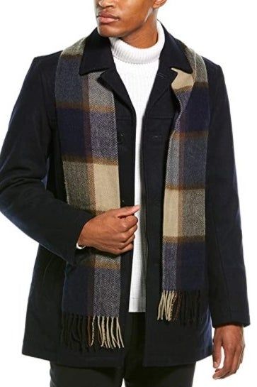 A model is wearing the jacket with the included scarf.