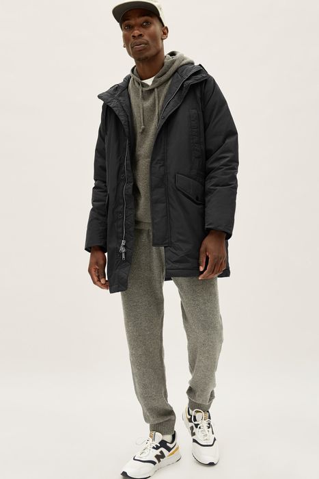 Model rocking the ReNew parka in black