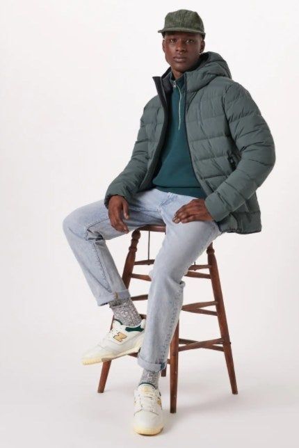 Model wearing the PrimaLoft jacket in grey